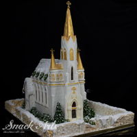 Gingerbread Church This gingerbread chapel is made from edible materials. It features a gingerbread wall and roof structure, candy window glass, fondant...