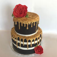 Gold Drip Cake Fondant wrapped cake with white chocolate ganache drip painted gold and gum paste roses.