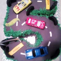 Hot Wheels Race Track Carved 5 cake with fondant and modeling chocolate decorations.