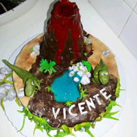 Vicente's Jurassic Park sponge cake stuffed with condensed cream topped with vanilla cream and brigadeiro