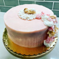 Baby Girl Cake Butter cream frosted cake with fondant flowers and baby decoration