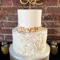 Elegant Wedding Cake 2 tier fondant covered wedding cake with fondant rosettes and hand painted edible beaded trim.