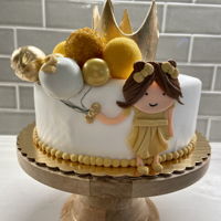 Gold Balloon Cake Fondant covered cake with fondant decorations, gum balls, and cake pops